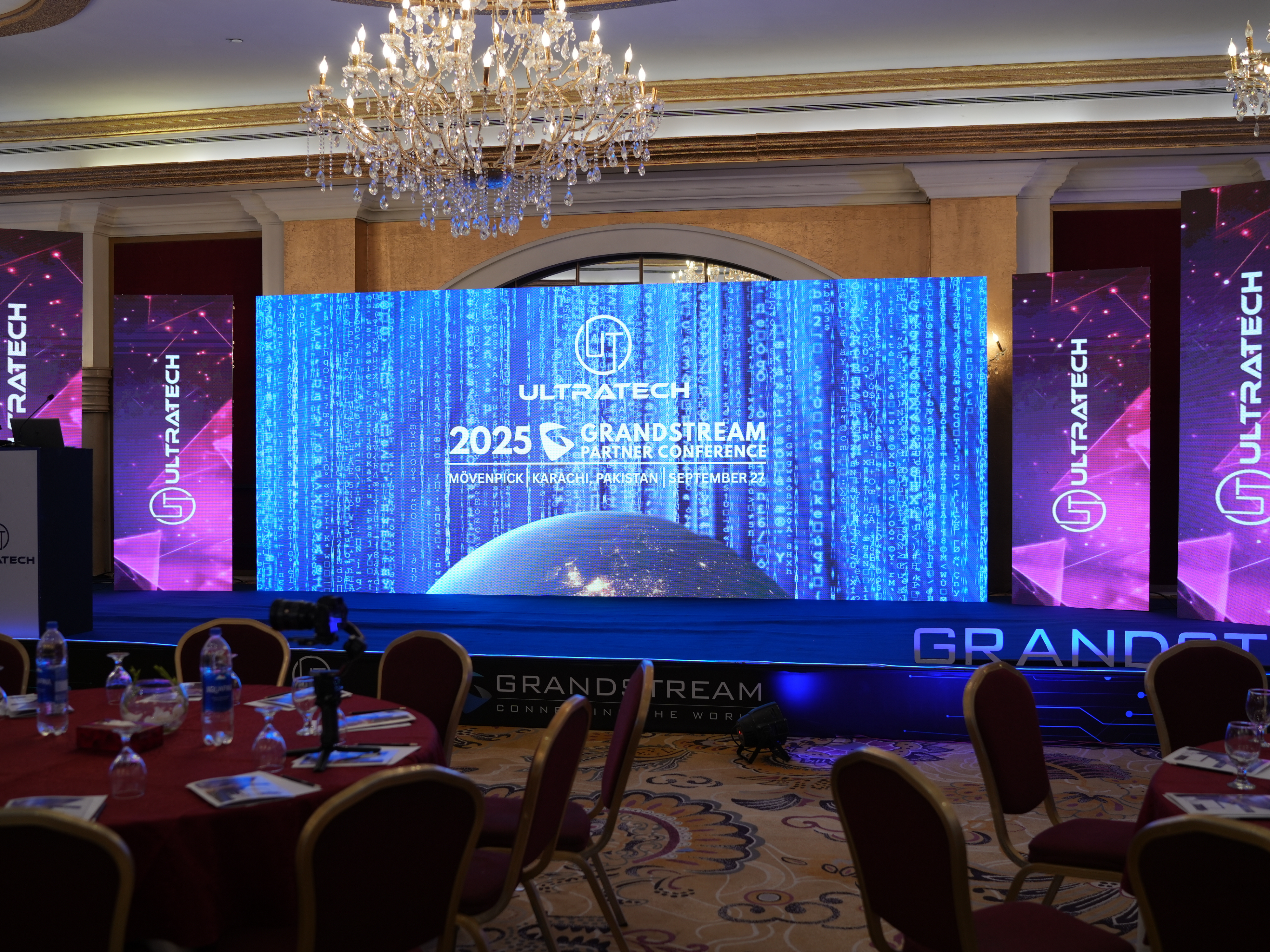 Conference room setup with a large screen displaying Ultratech branding.