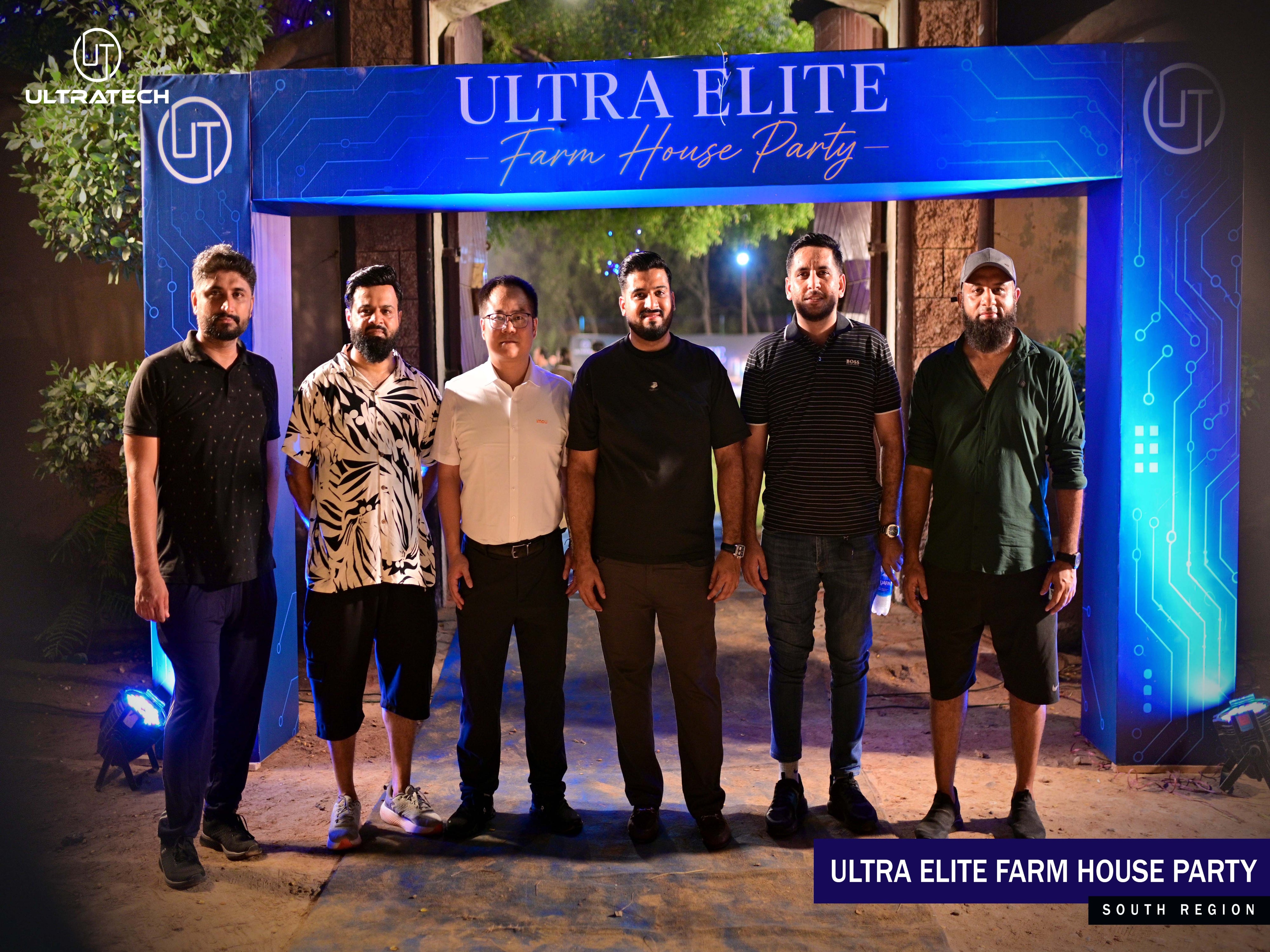 Six men standing together in front of a large illuminated blue archway that reads 'ULTRA ELITE Farm House Party' at night. The scene appears to be an event or venue entrance, with trees and ambient lighting visible in the background.